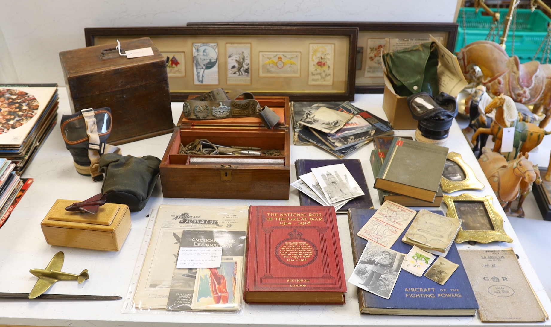 A quantity of war memorabilia including gas masks, postcards etc